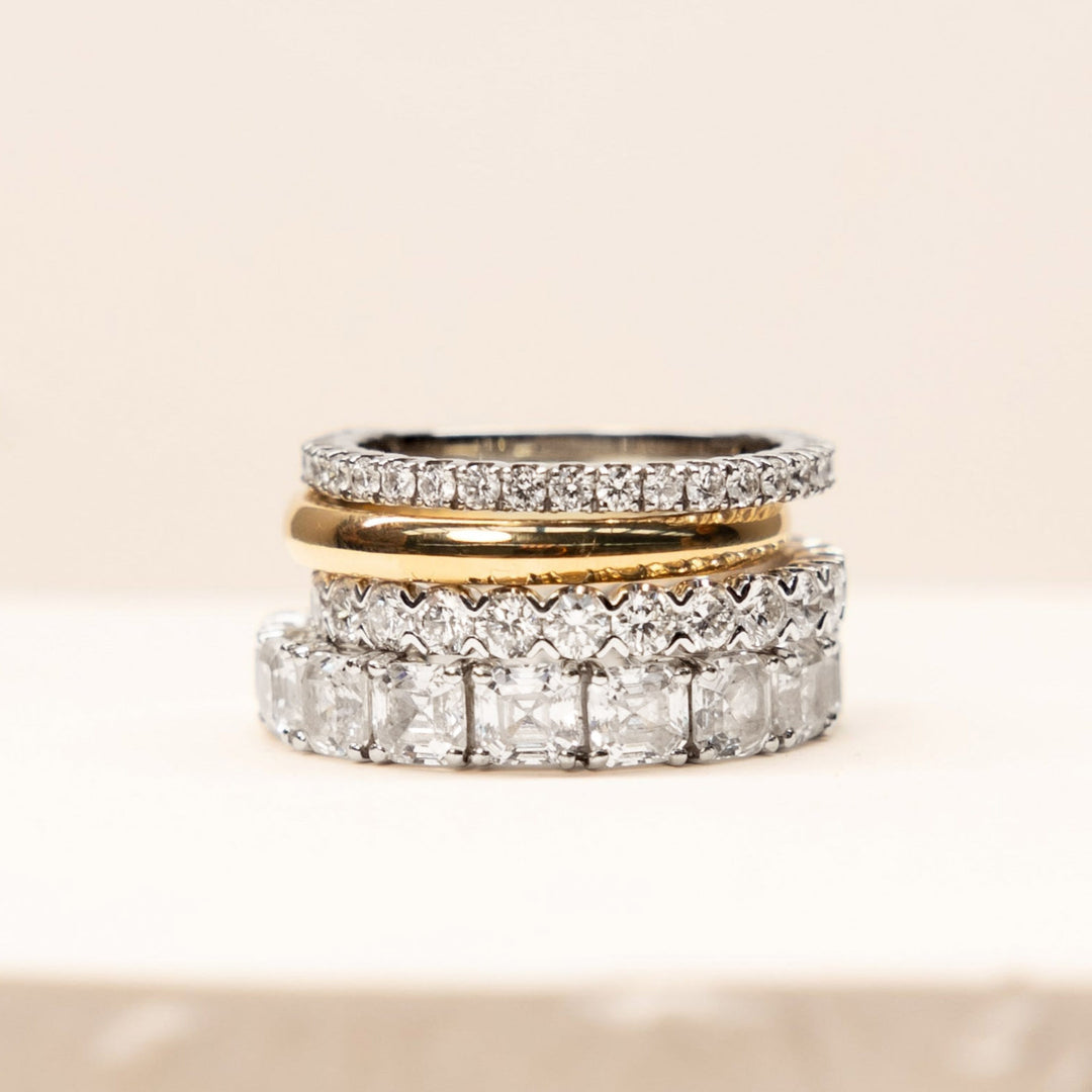 diamond wedding bands stacked on each other on a marble tray