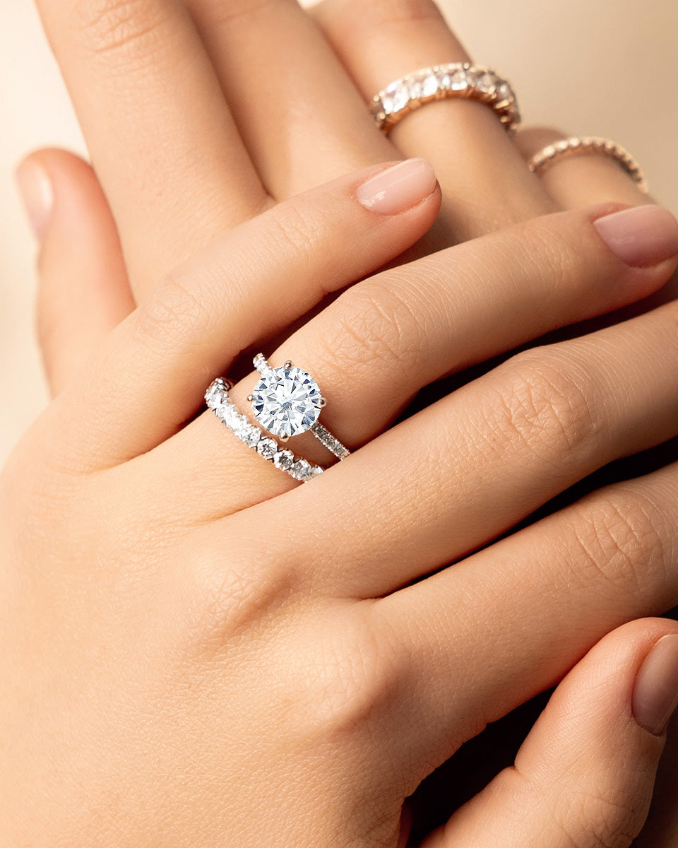 woman's hand with multiple striking diamond rings