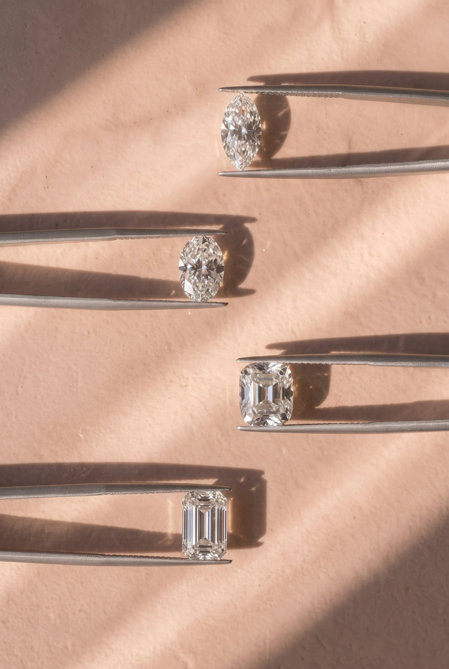 Diamonds in various cuts on grey background