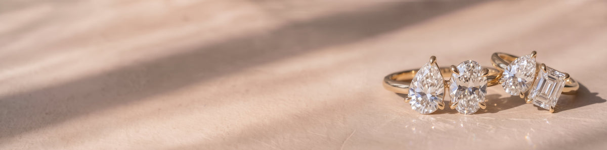 Toi et Moi Lab-grown Diamond Engagement Rings on a soft beige background | The Jewel Concierge