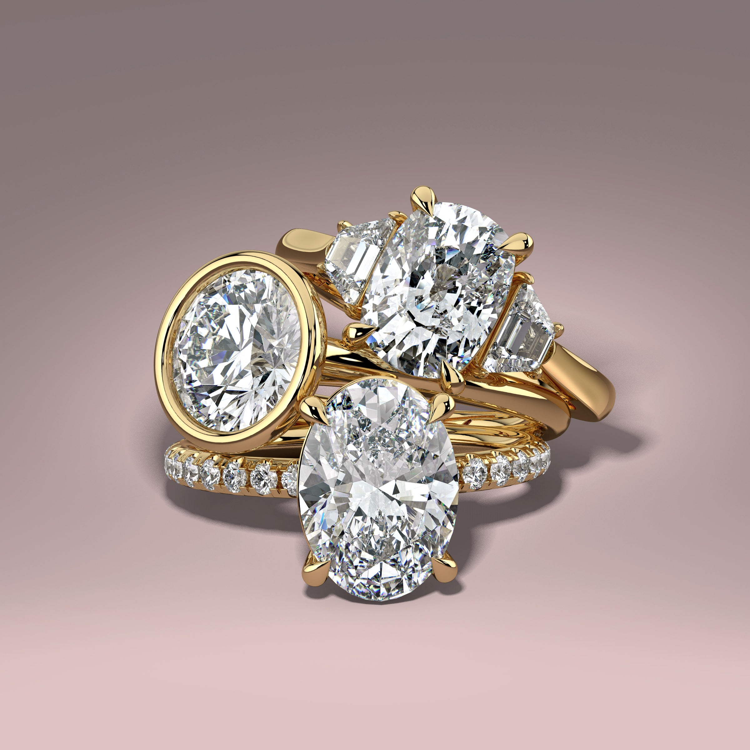 three beautiful diamond engagement rings stacked on top of each other on a luxurious grey background