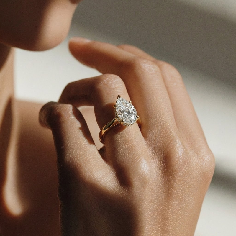 Aquila Ring — pear lab grown diamond cathedral with hidden halo & pavé bridge engagement ring in yellow gold — The Jewel Concierge