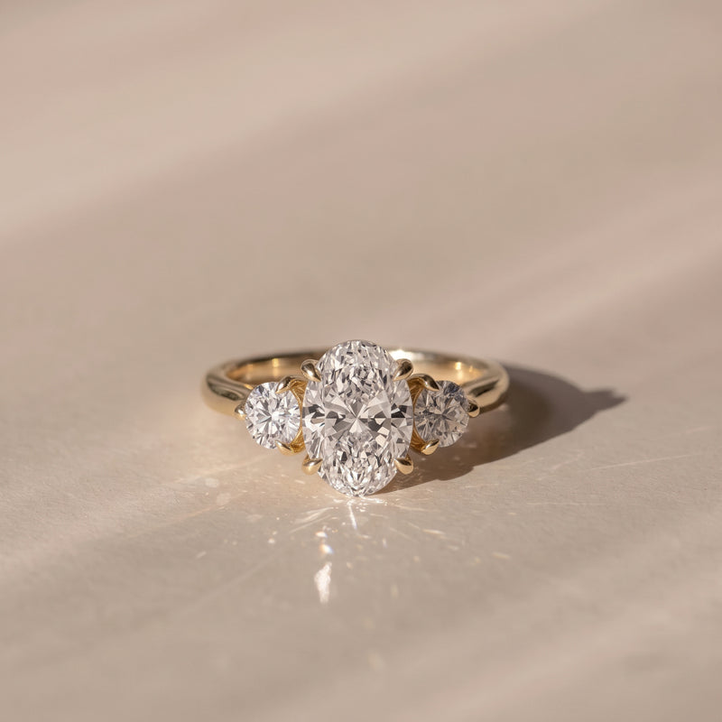 The Annalise Ring — Oval and Round Trilogy Lab-Grown Diamond Engagement Ring in Yellow Gold | The Jewel Concierge