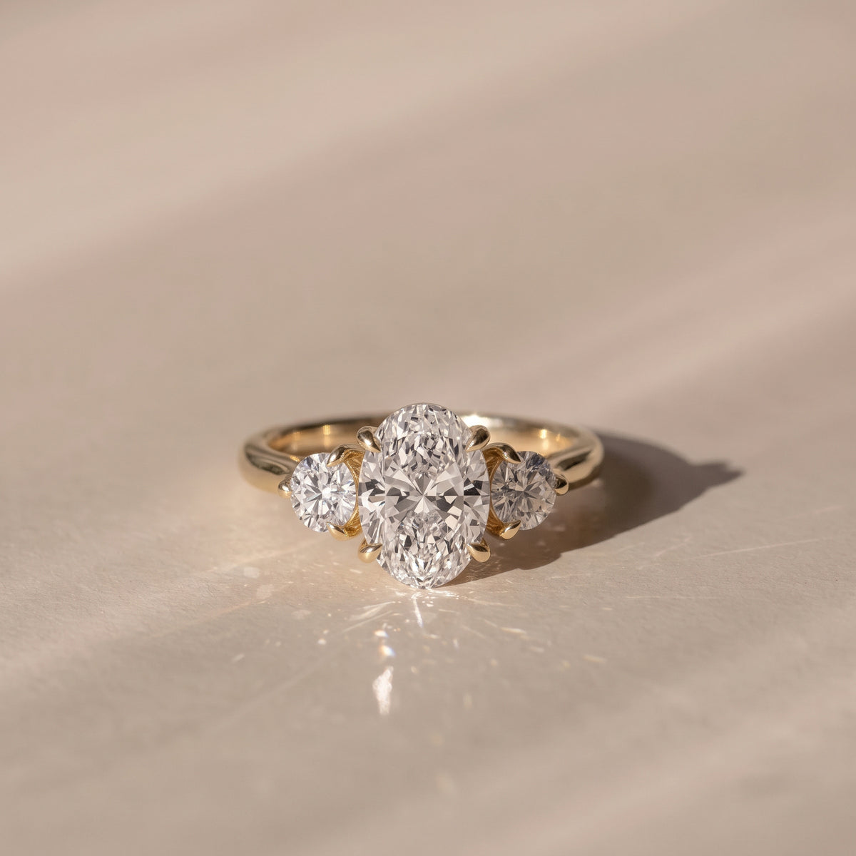 The Annalise Ring — Oval and Round Trilogy Lab-Grown Diamond Engagement Ring in Yellow Gold | The Jewel Concierge