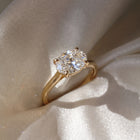 The Aria Ring — East-West Oval Solitaire Lab-Grown Diamond Engagement Ring in Yellow Gold on a Luxurious Silk Fabric  | The Jewel Concierge