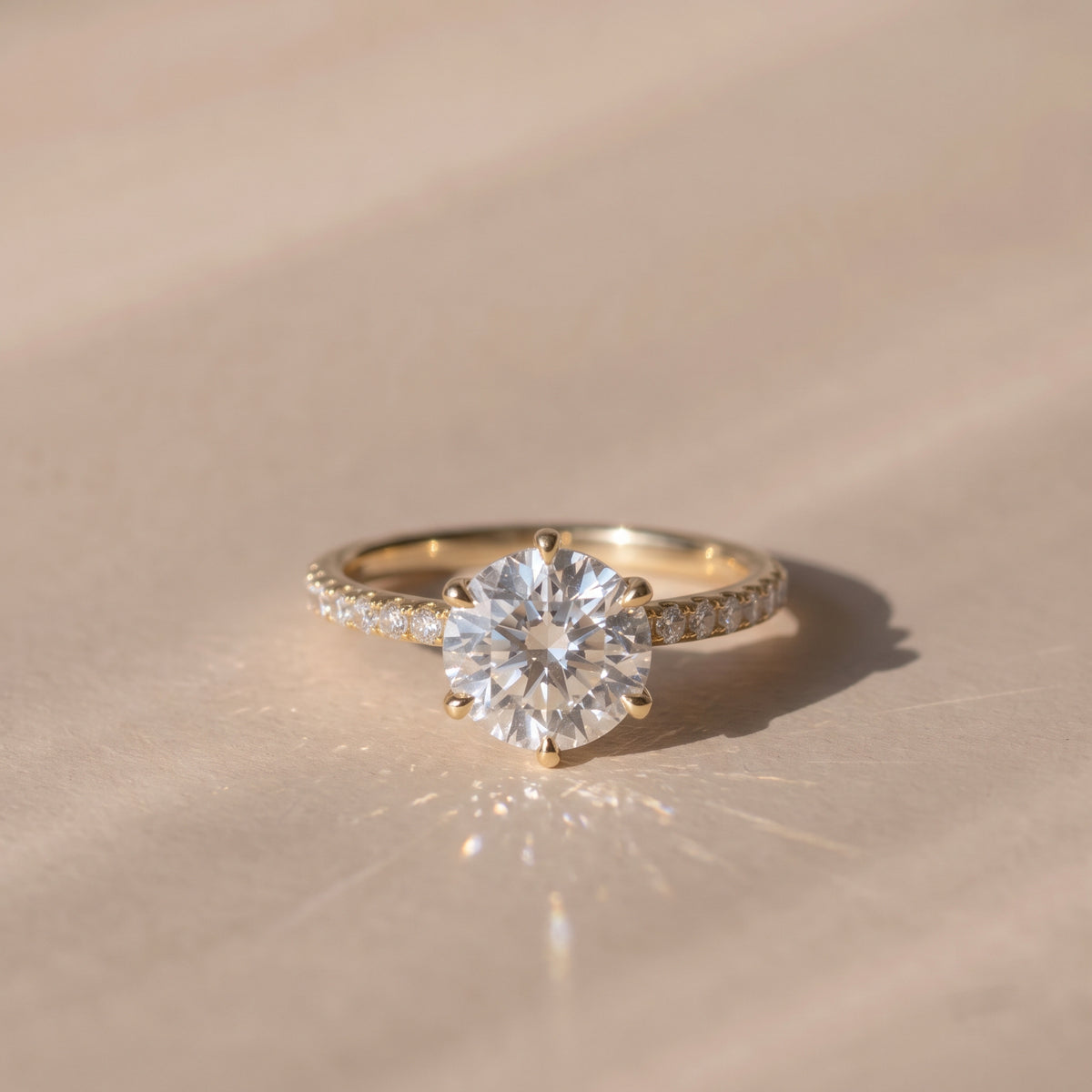 The Astra Ring — 6 Claw Round Solitaire with Pavé Band Lab-Grown Diamond Engagement Ring in Yellow Gold | The Jewel Concierge