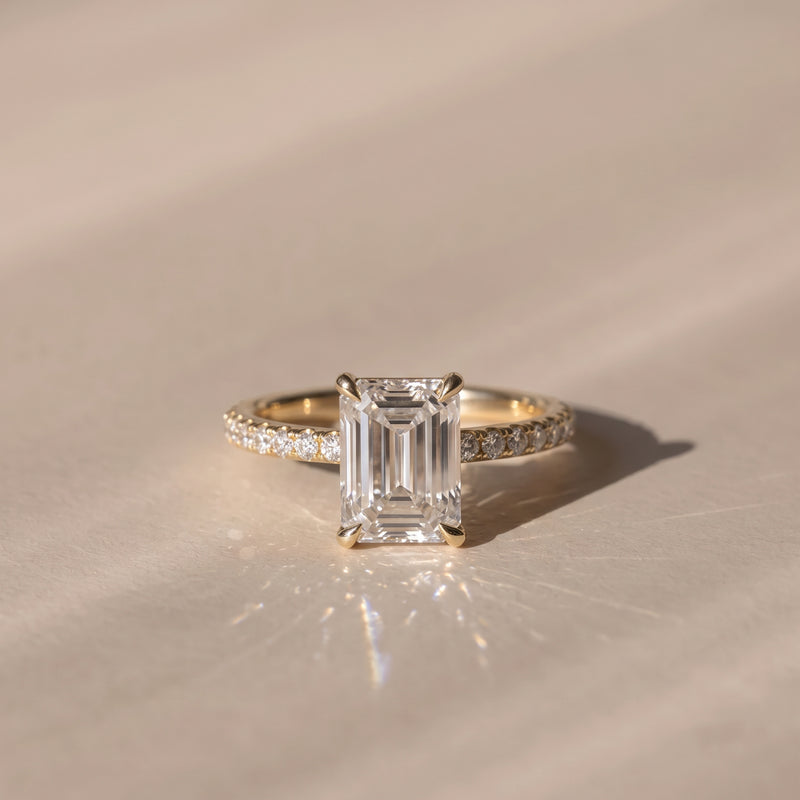The Astra Ring — Emerald Solitaire with Pavé Band Lab-Grown Diamond Engagement Ring in Yellow Gold | The Jewel Concierge