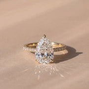 The Astra Ring — Pear Solitaire with Pavé Band Lab-Grown Diamond Engagement Ring in Yellow Gold | The Jewel Concierge