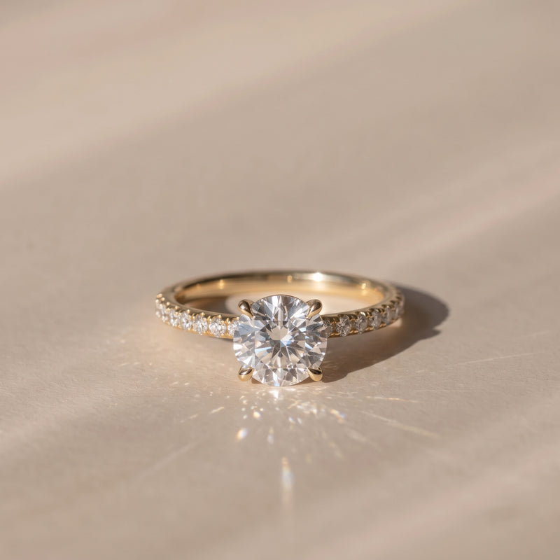 The Astra Ring — 4 Claw Round Solitaire with Pavé Band Lab-Grown Diamond Engagement Ring in Yellow Gold | The Jewel Concierge