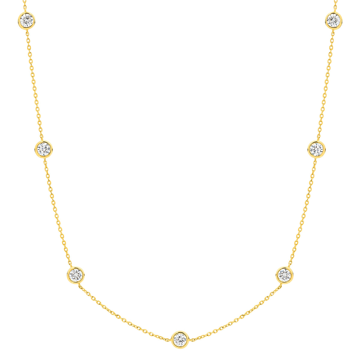 A delicate bezel by the yard gold chain necklace featuring nine small, round bezel-set clear lab-grown diamonds spaced evenly along the chain, displayed against a solid white background  - The Jewel Concierge