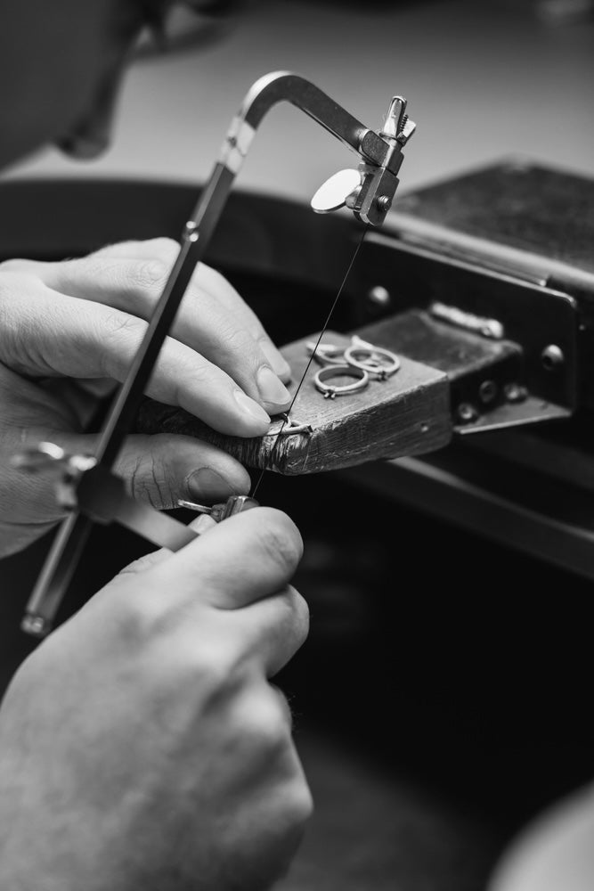 master jeweller working on a diamond ring  with his tools