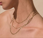 The Figaro Chain - three Figaro Chains in different lengths, elegantly layered on a model's neck, crafted in yellow gold | The Jewel Concierge