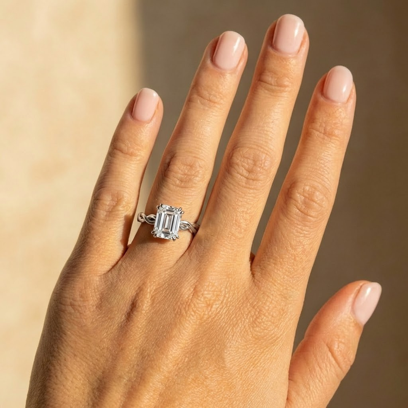 Elysande Ring — emerald lab grown diamond solitaire with braided band engagement ring in gold — The Jewel Concierge