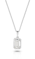 A yellow gold pendant featuring an emerald lab-grown diamond, set in a bezel setting against a clean white background with a soft reflection - The Jewel Concierge