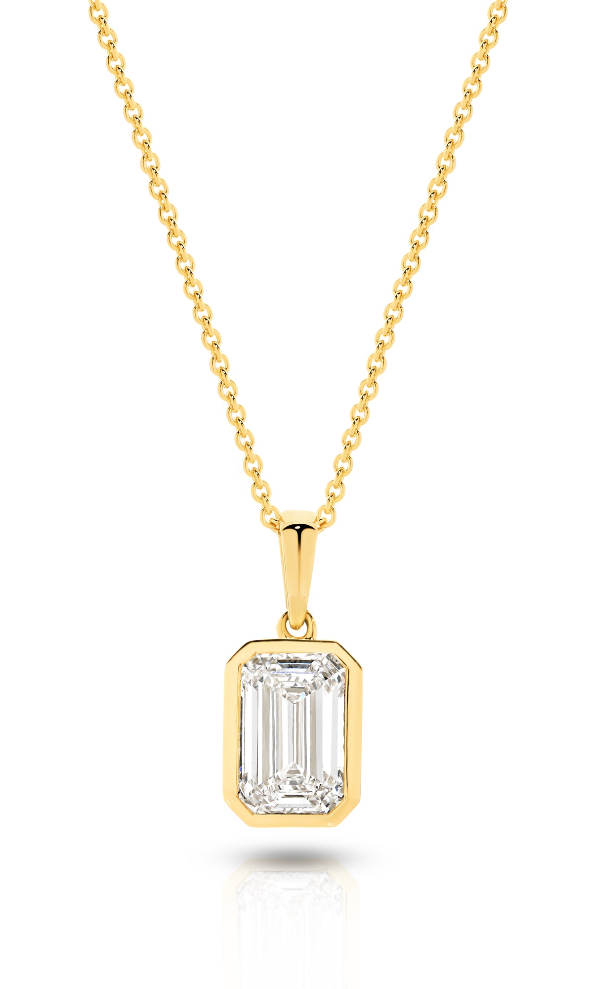 A yellow gold pendant featuring an emerald lab-grown diamond, set in a bezel setting against a clean white background with a soft reflection - The Jewel Concierge