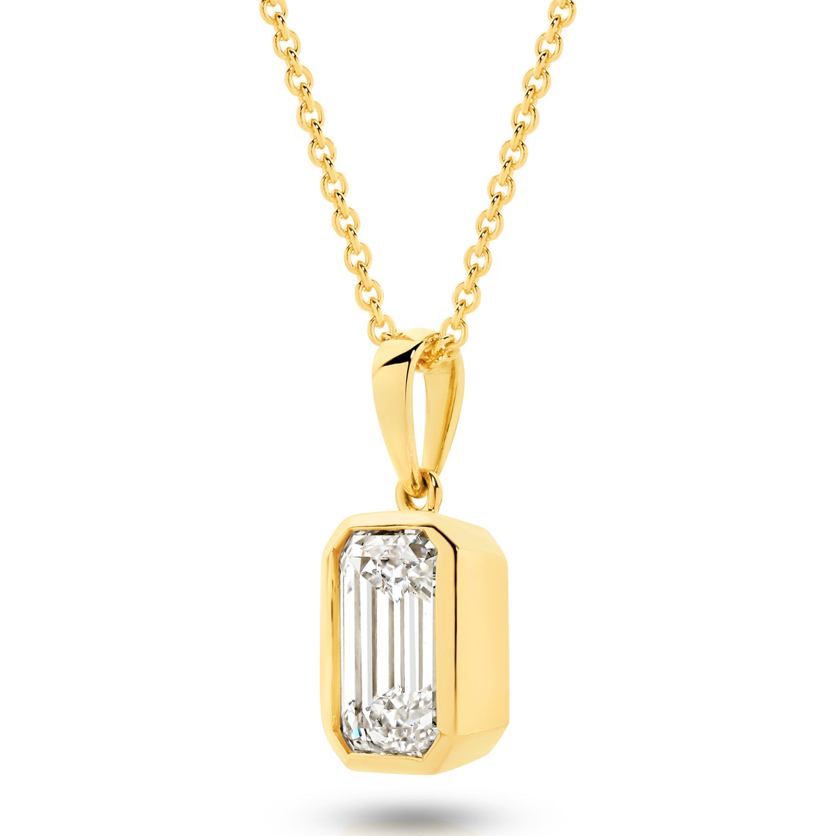 A yellow gold pendant featuring an emerald lab-grown diamond, set in a bezel setting against a clean white background with a soft reflection - The Jewel Concierge