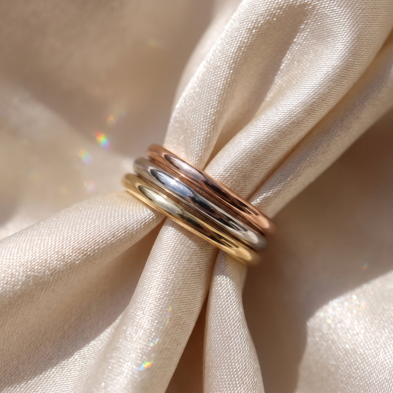 The Emily Ring - plain half rounded wedding band, laid elegantly on a luxurious silk fabric | The Jewel Concierge