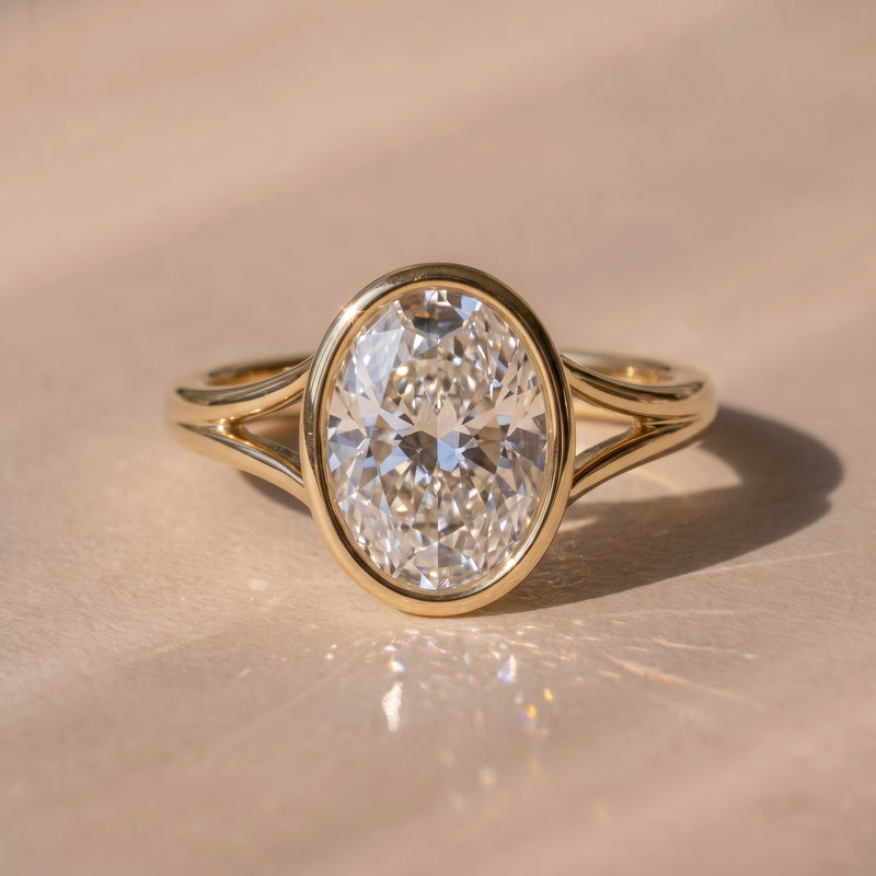 The Gabriella Ring — Oval Bezel with Split Band Lab-Grown Diamond Engagement Ring in Yellow Gold | The Jewel Concierge