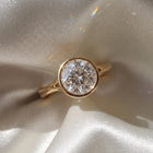 The Gabriella Ring — Round Bezel with Split Band Lab-Grown Diamond Engagement Ring in Yellow Gold | The Jewel Concierge