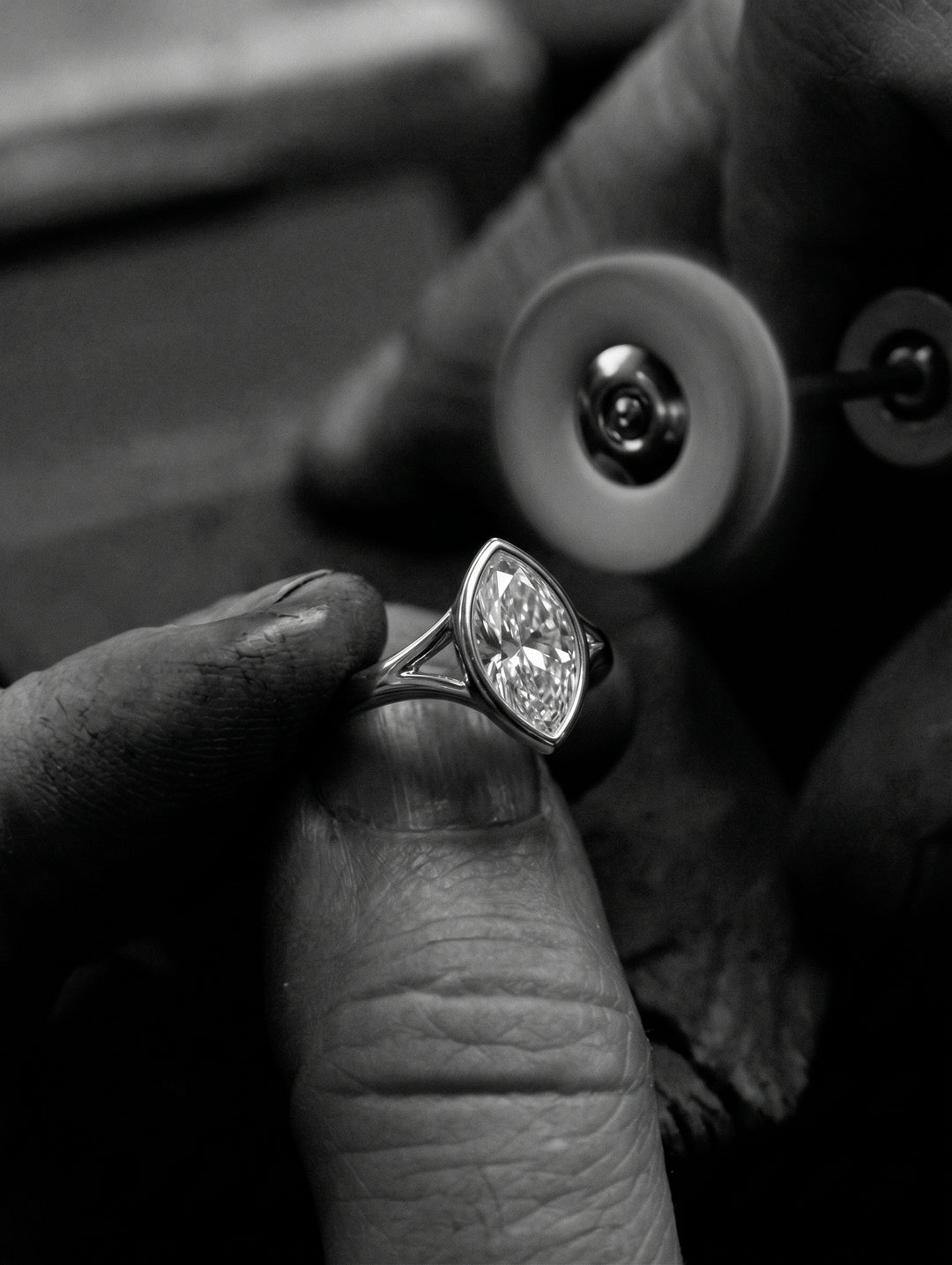 Jeweller Polishing and carefully inspecting The Gabriella Ring - Marquise Bezel with Split Band | The Jewel Concierge