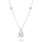 A white gold necklace featuring a delicate chain with five small round bezel-set lab-grown diamonds spaced along the chain, ending with a pear-cut lab-grown diamond solitaire, shown on a white background - The Jewel Concierge