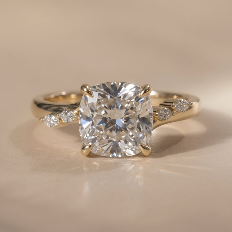 The Madeline Ring — Cushion with Twisted Accent Band Lab-Grown Diamond Engagement Ring on a luxurious beige background | The Jewel Concierge