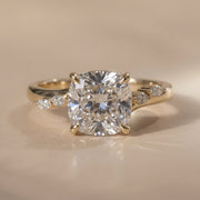 The Madeline Ring — Cushion with Twisted Accent Band Lab-Grown Diamond Engagement Ring on a luxurious beige background | The Jewel Concierge