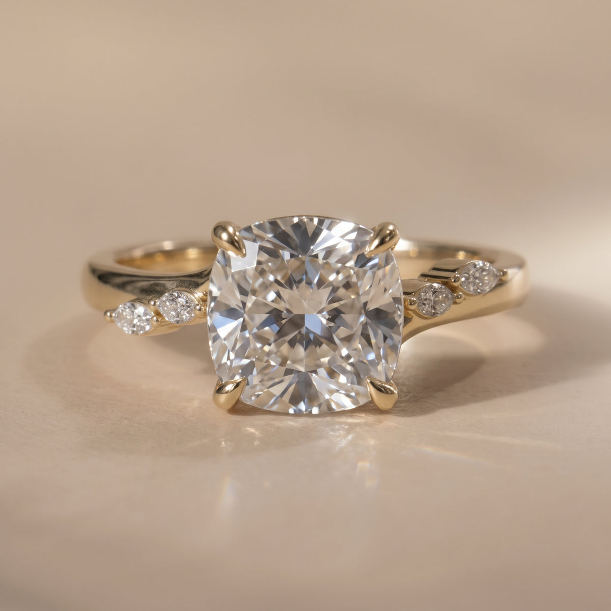 The Madeline Ring — Cushion with Twisted Accent Band Lab-Grown Diamond Engagement Ring on a luxurious beige background | The Jewel Concierge