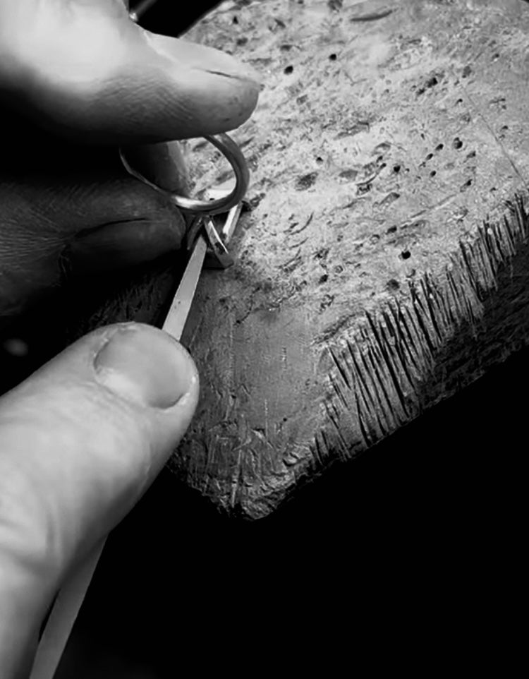 jeweller crafting an 18K engagement ring on a jeweller's bench
