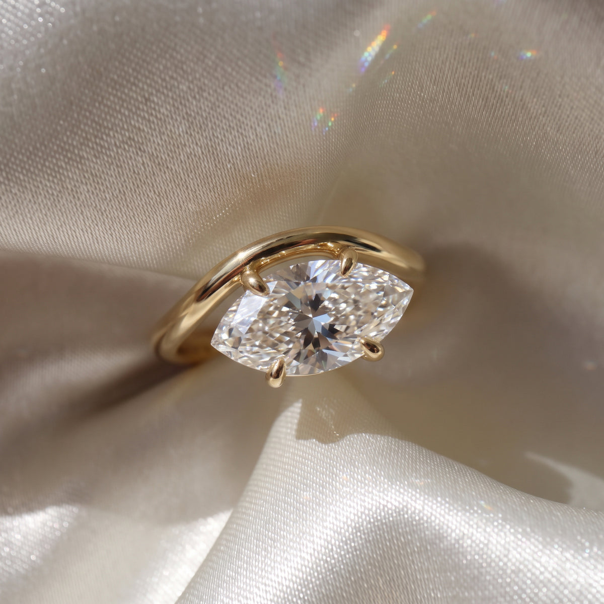The Solis Ring — Curved East West Marquise Cut on a luxurious silk fabric | The Jewel Concierge