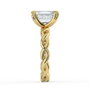 The Elysande Ring – Emerald Solitaire with Braided Band in 18K Yellow Gold – The Jewel Concierge