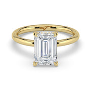 The Celeste Ring – Emerald Solitaire with Hidden Halo in 14K Yellow Gold – The Jewel Concierge
