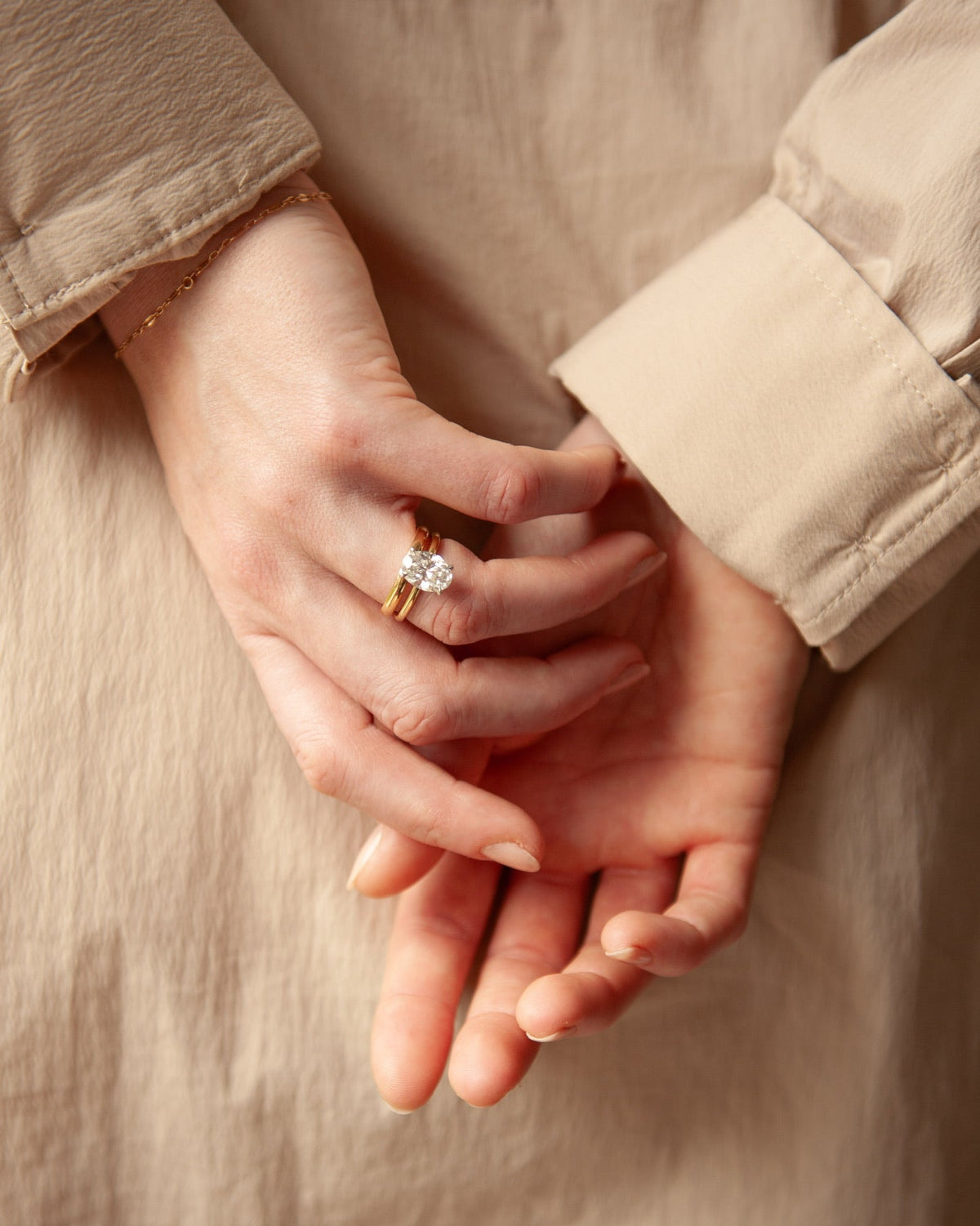 The Celeste Ring - 2.51ct oval solitaire with hidden halo in 18k yellow & white gold, stacked with a plain yellow gold wedding band | The Jewel Concierge