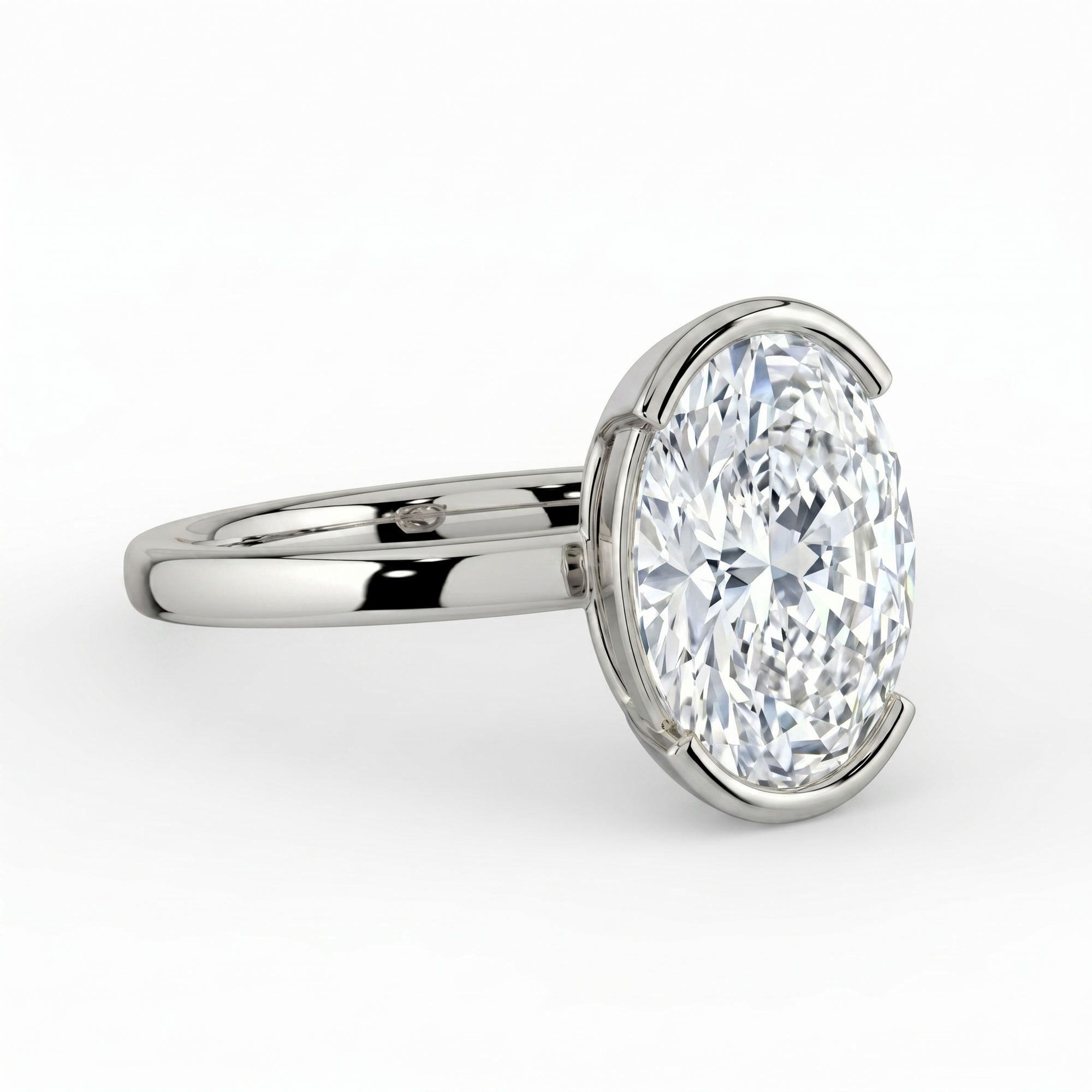The Celine Ring – Oval Half Bezel Solitaire in 18K White Gold – The Jewel Concierge