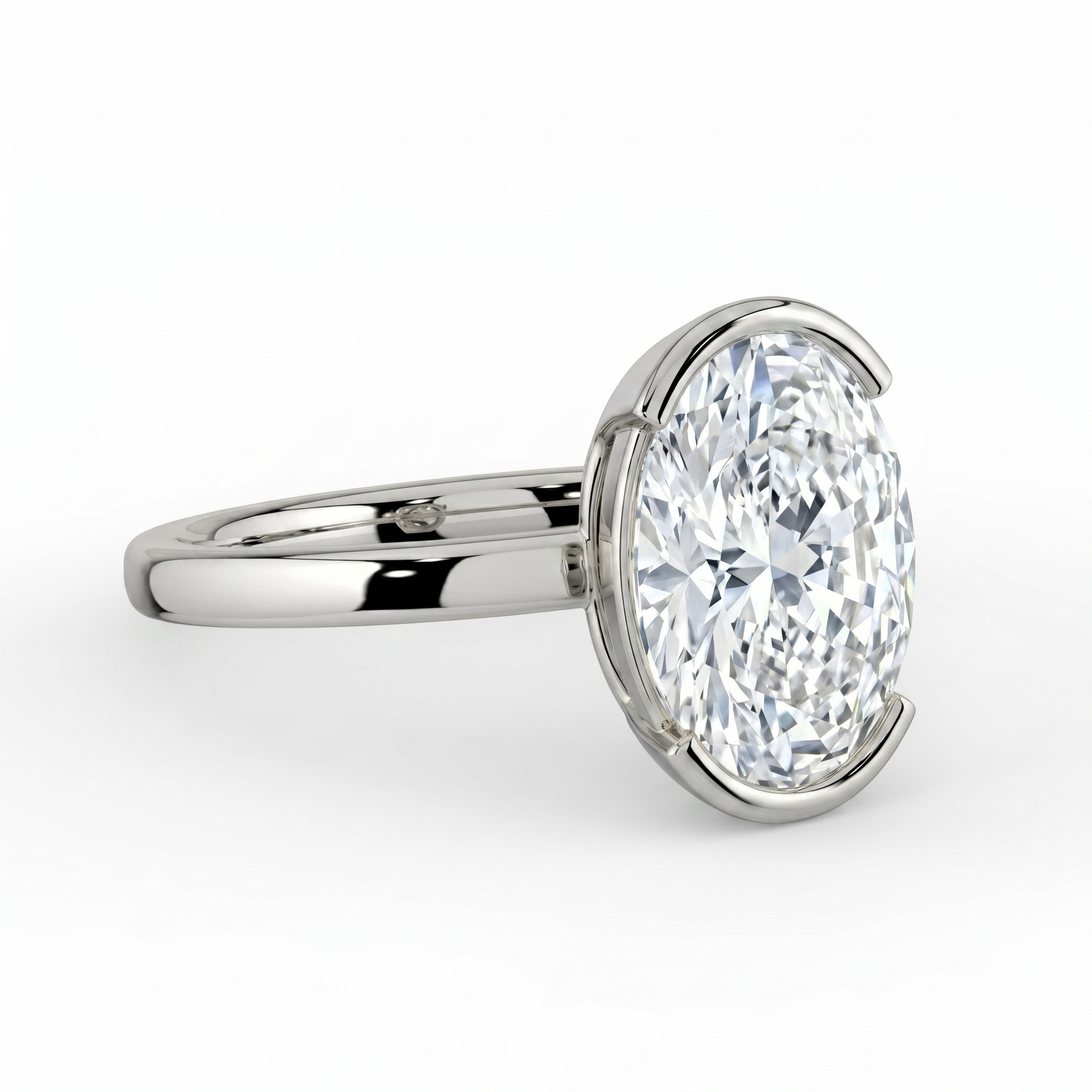 The Celine Ring – Oval Half Bezel Solitaire in 18K White Gold – The Jewel Concierge