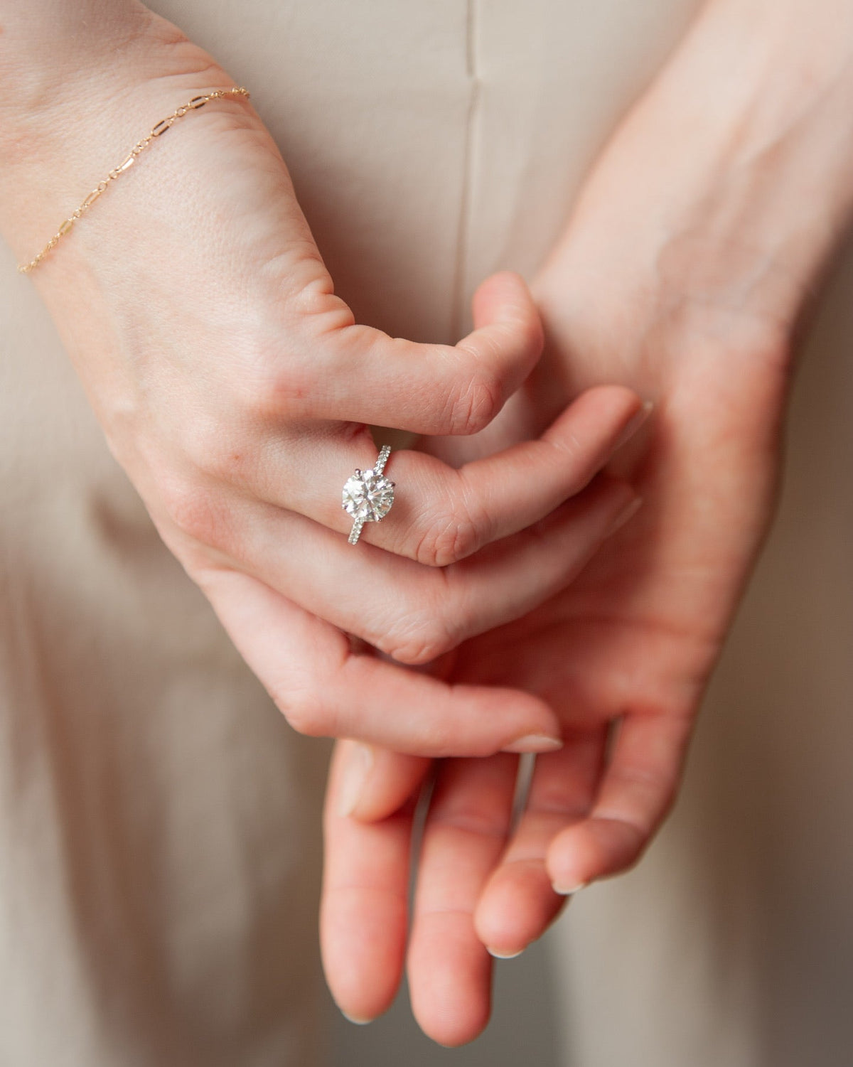 A model elegantly showcasing The Phoenix Ring, featuring a 3.05ct Round cut lab-grown diamond with a pave band, finished in 18K white gold | The Jewel Concierge