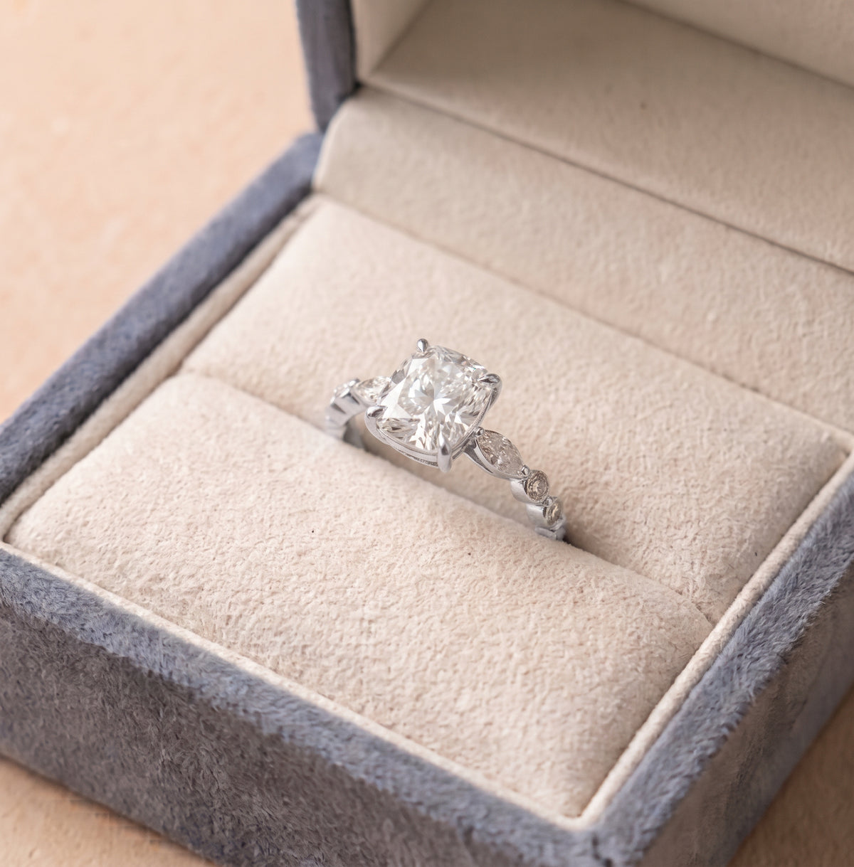 The Vega Ring - Cushion Solitaire with accent band, finished in 18K white gold, inside The Jewel Concierge's signature ring box | The Jewel Concierge