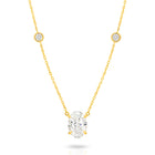 A yellow gold necklace featuring a delicate chain with five small round bezel-set lab-grown diamonds spaced along the chain, ending with an oval-cut lab-grown diamond solitaire pendant, shown on a white background - The Jewel Concierge