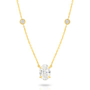 A yellow gold necklace featuring a delicate chain with five small round bezel-set lab-grown diamonds spaced along the chain, ending with an oval-cut lab-grown diamond solitaire pendant, shown on a white background - The Jewel Concierge