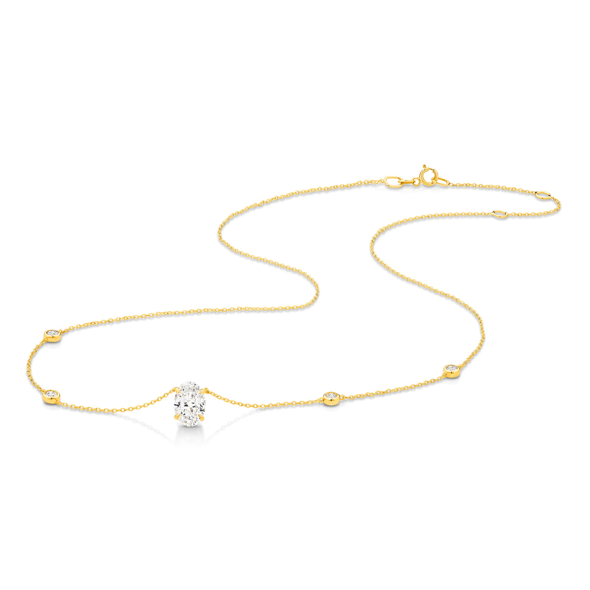 A yellow gold necklace featuring a delicate chain with five small round bezel-set lab-grown diamonds spaced along the chain, ending with an oval-cut lab-grown diamond solitaire pendant, shown on a white background - The Jewel Concierge