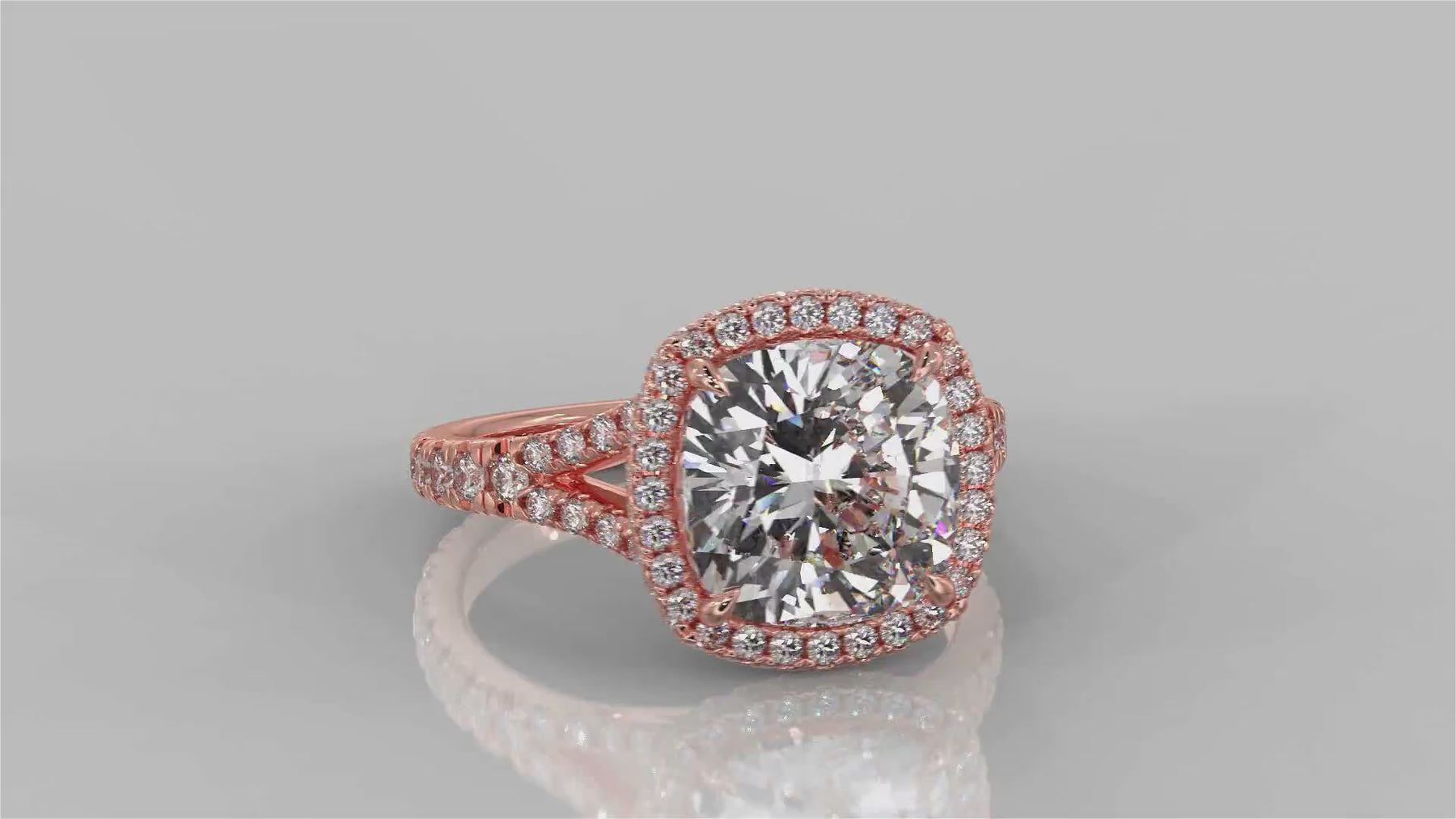 Video of a cushion cut lab-grown diamond engagement ring in 18K rose gold elegantly turning and showcasing its beauty and sparkle from all angles - The Jewel Concierge 