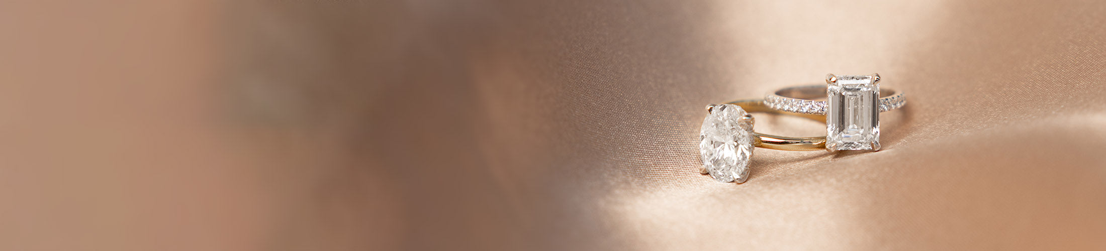 Two diamond rings on a rose gold surface